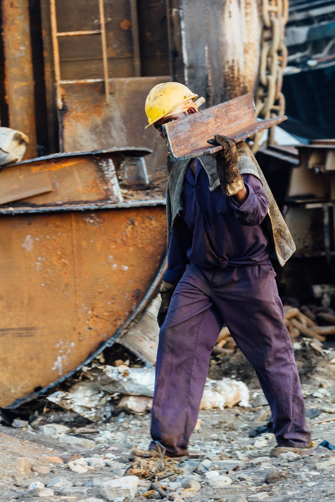 "Shipbreaker Hauling Steel Beam, Alang Shipyards" by AdamCohn is licensed under CC BY-NC-ND 2.0